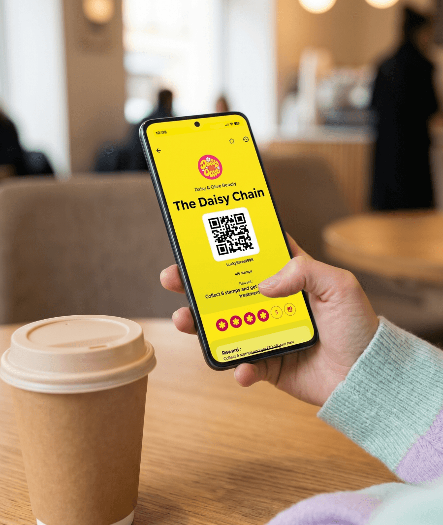 A customer using a Loytu loyalty card on their phone in a coffee shop